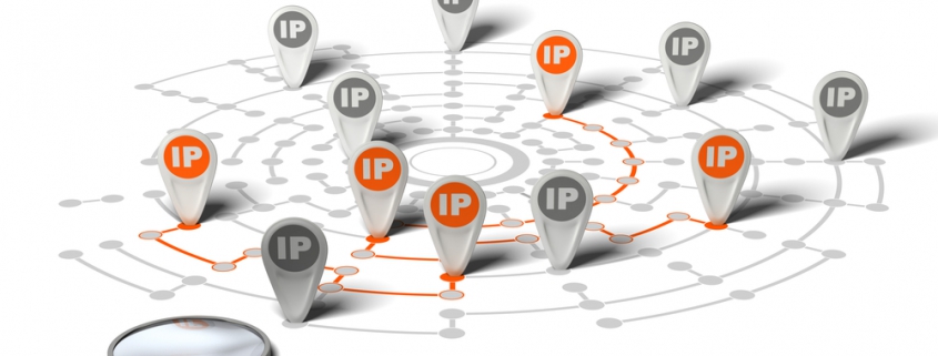 Many flags withe the word IP pined on network over white background and a magnifier. Concept image for illustration of IP tracking.